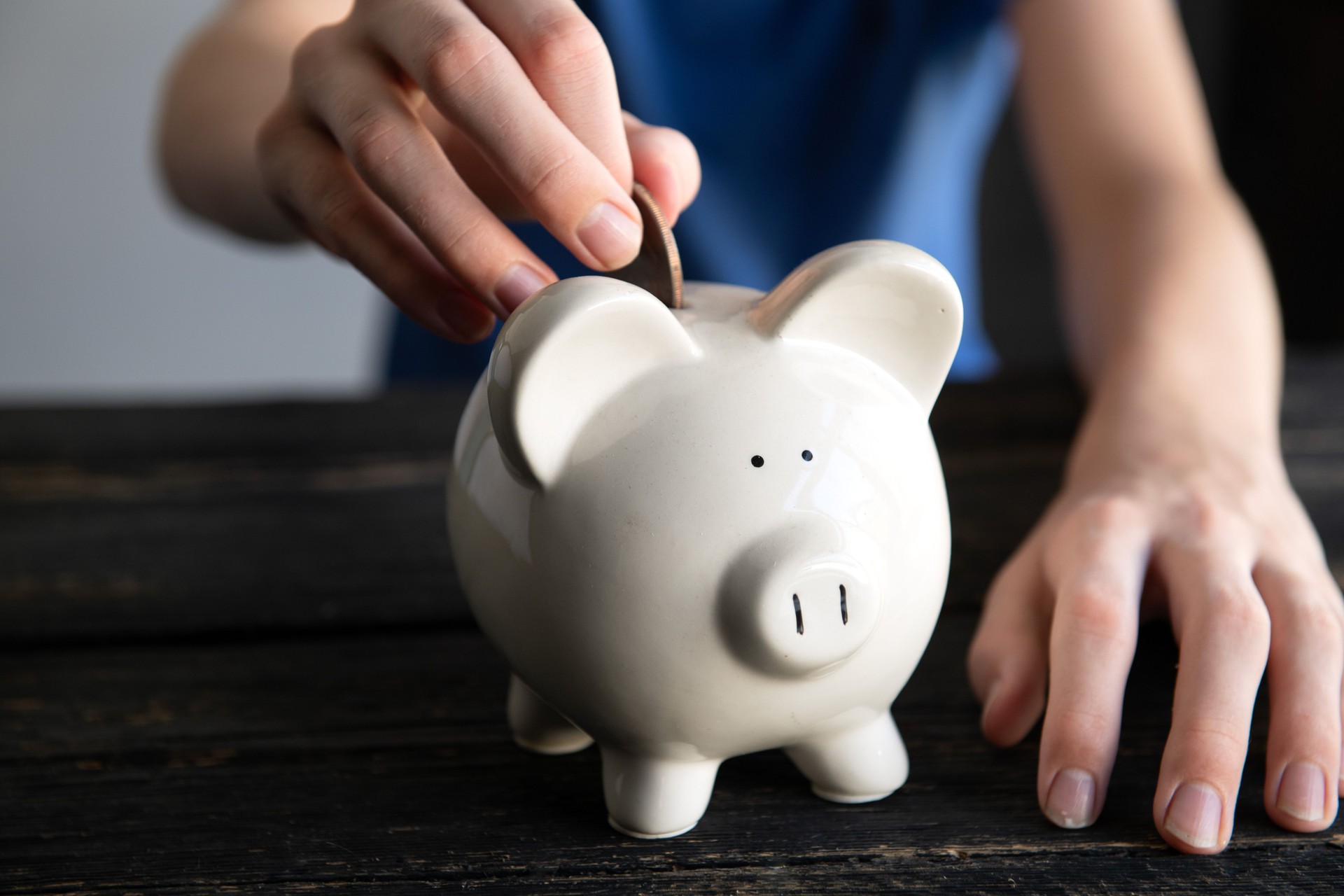 Male hand holding piggy bank. Save money and financial investment