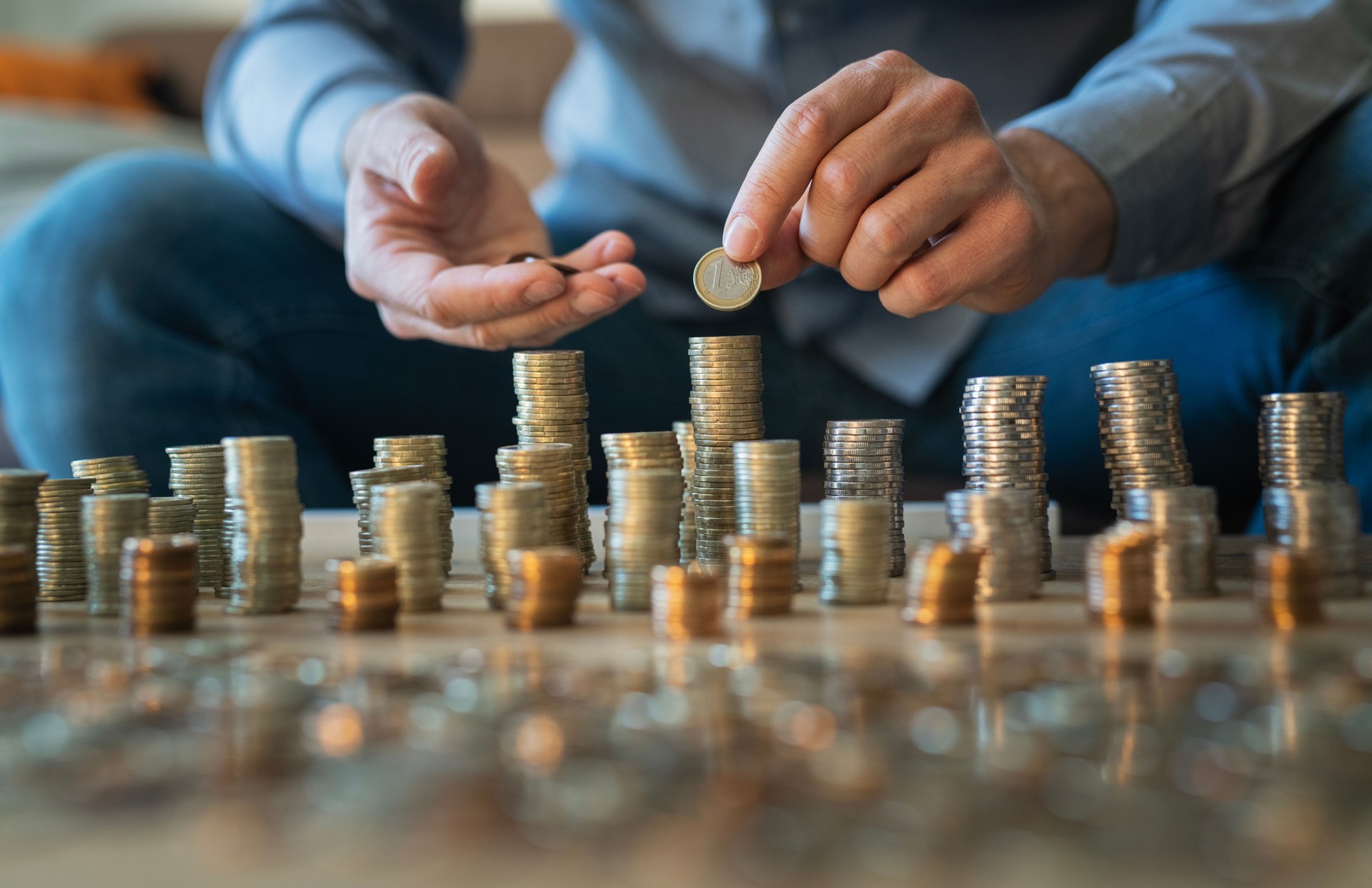 Male hands using last money from money box for taxes and bills.